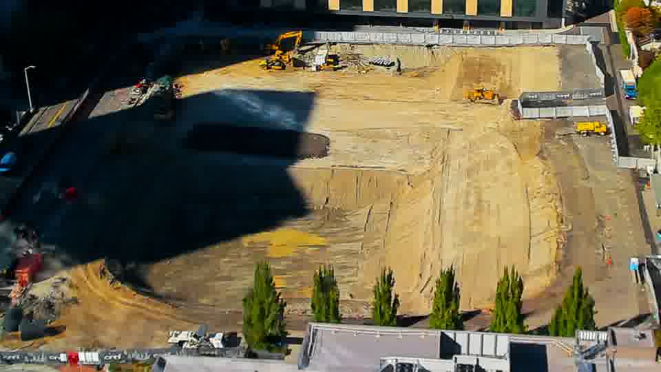 Construction camera frame at 3:45 PM PT. A yellow machine has moved slightly within the site, shifting its position towards the center.
