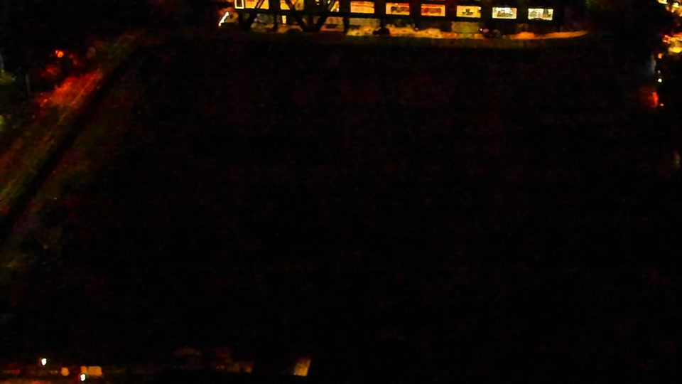 Construction camera frame at 11:00 PM PT. Visibility is too low to assess construction activity.
