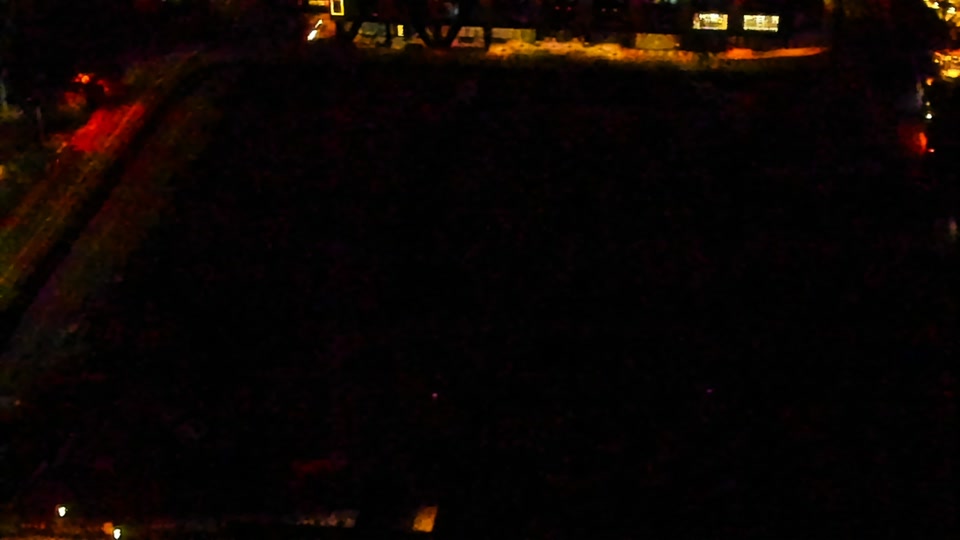 Construction camera frame at 12:00 AM PT. Visibility is too low to assess construction activity.