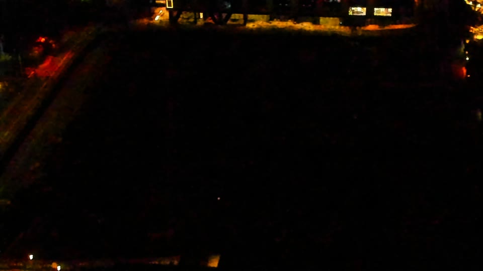 Construction camera frame at 5:00 AM PT. Visibility is too low to assess construction activity.