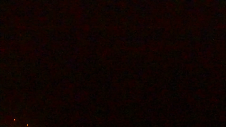 Construction camera frame at 4:00 AM PT. Visibility is too low to assess construction activity.