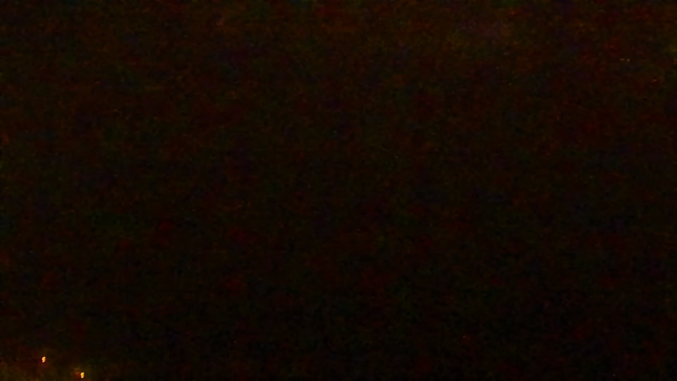 Construction camera frame at 6:00 AM PT. Visibility is too low to assess construction activity.