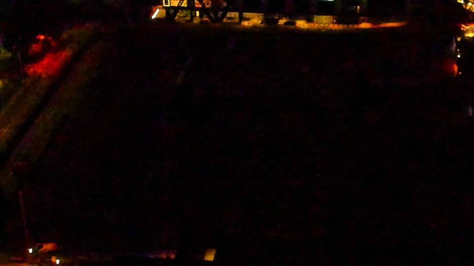 Construction camera frame at 11:00 PM PT. Visibility is too low to assess construction activity.